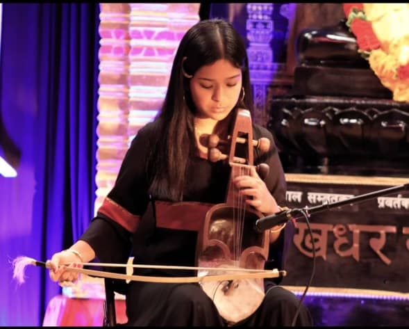 Yeju Shrestha performing the Sarangi on stage